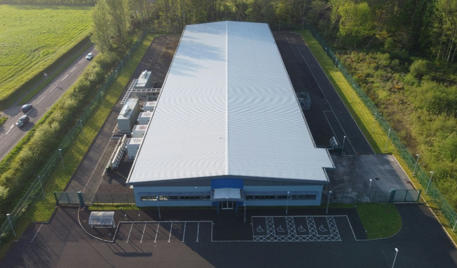Aerial view of UK commercial buildings with large flat rooftops suitable for solar PV